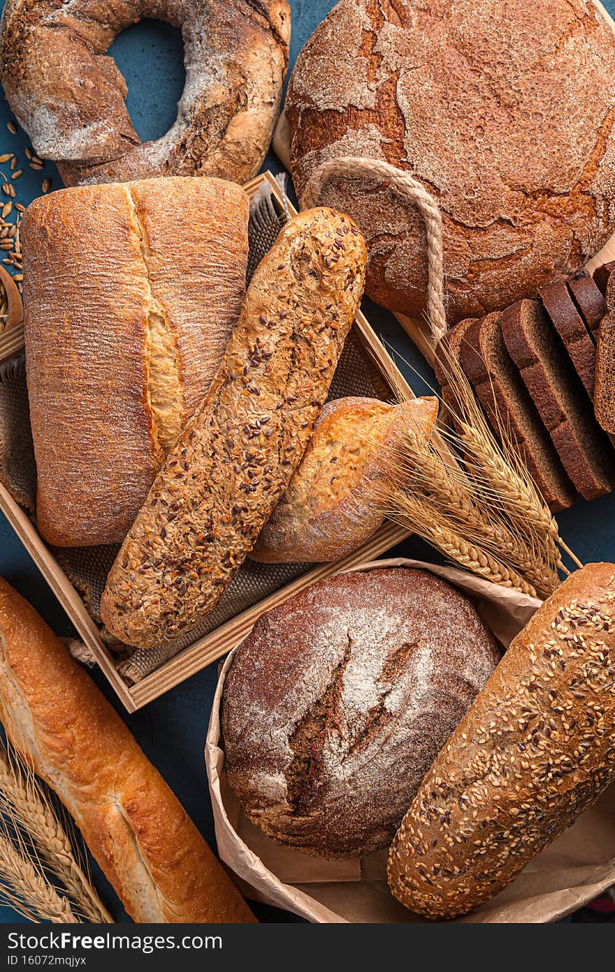 Fresh, crispy bread of various types and wheat close-up. Top view. Bread fund.