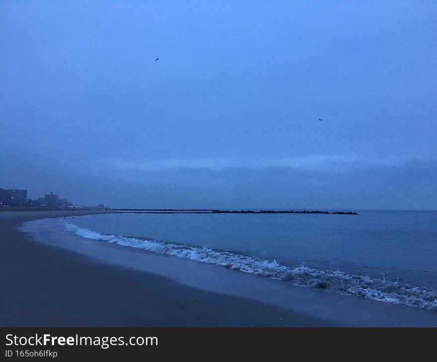 Cloudy Dawn in Winter at Coney Island in Brooklyn in New York, NY.