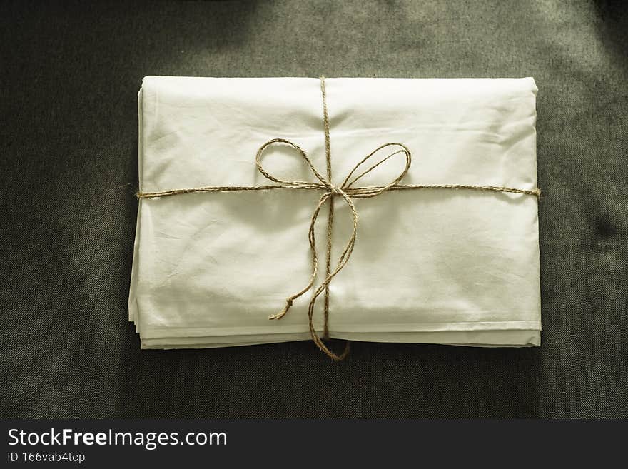 Set of white bedding on gray background close up