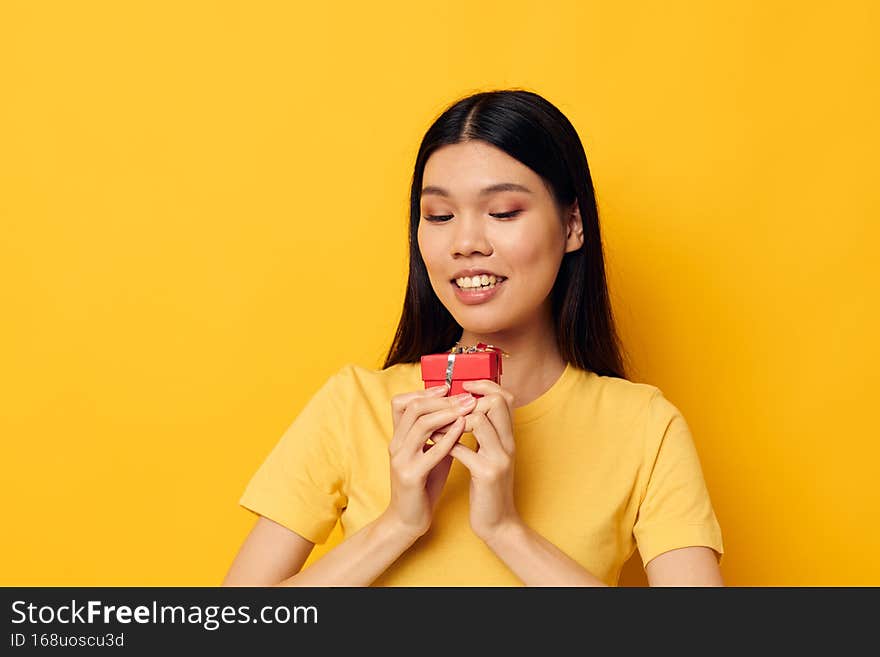 Portrait Asian beautiful young woman holding a gift box in his hands posing Lifestyle unaltered
