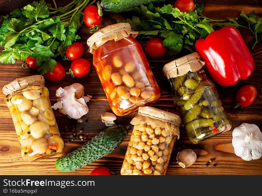 homemade canned vegetables on wooden background