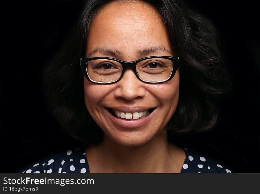 Portrait of a beautiful happy woman in front of a colored background. High quality photo