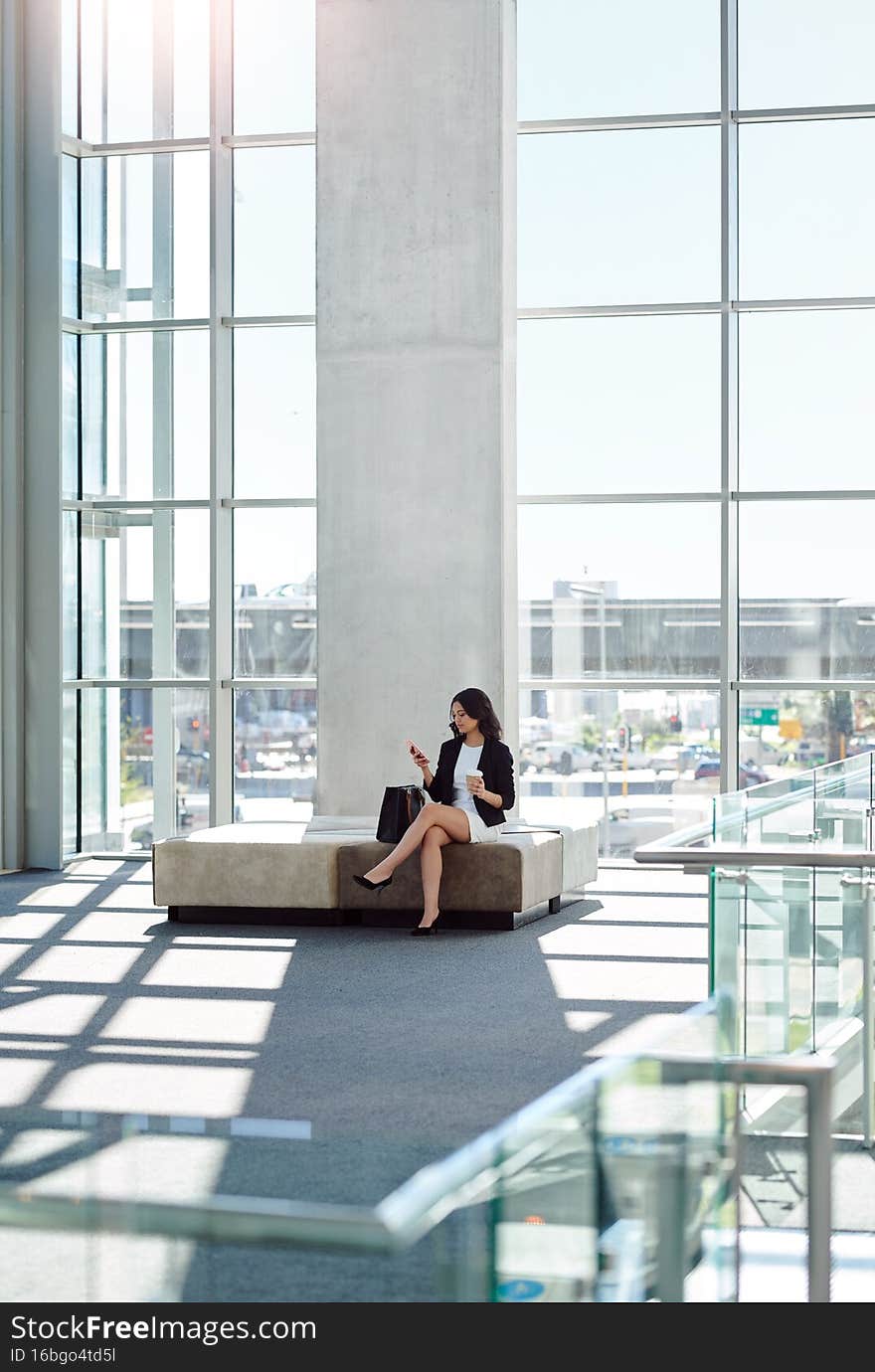 She masters the art of communication. Full length shot of an attractive young businesswoman using a smartphone while