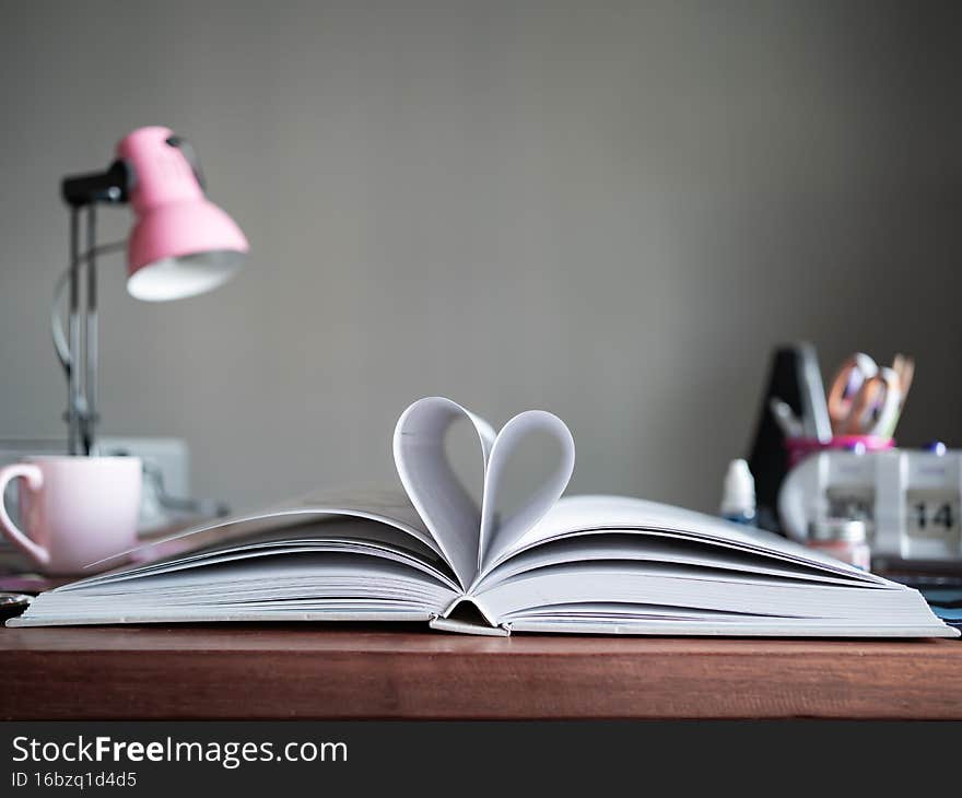 Heart symbol made from a book with copy space for text.