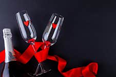 Heart Shapes In Empty Flutes Wrapped With Red Ribbon By Champagne Bottle Royalty Free Stock Photography