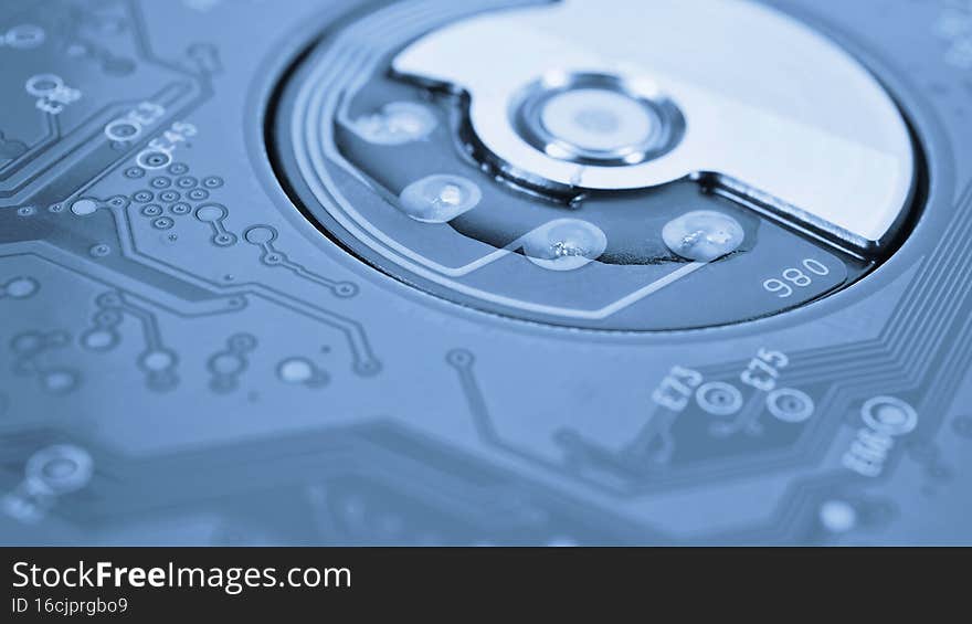 Printed circuit board PCB hard drive. Fragment of printed wiring board PWB closeup. Conductive patterns. IT. Blue tinted background or wallpaper. PC computer hardware and data storage. Macro