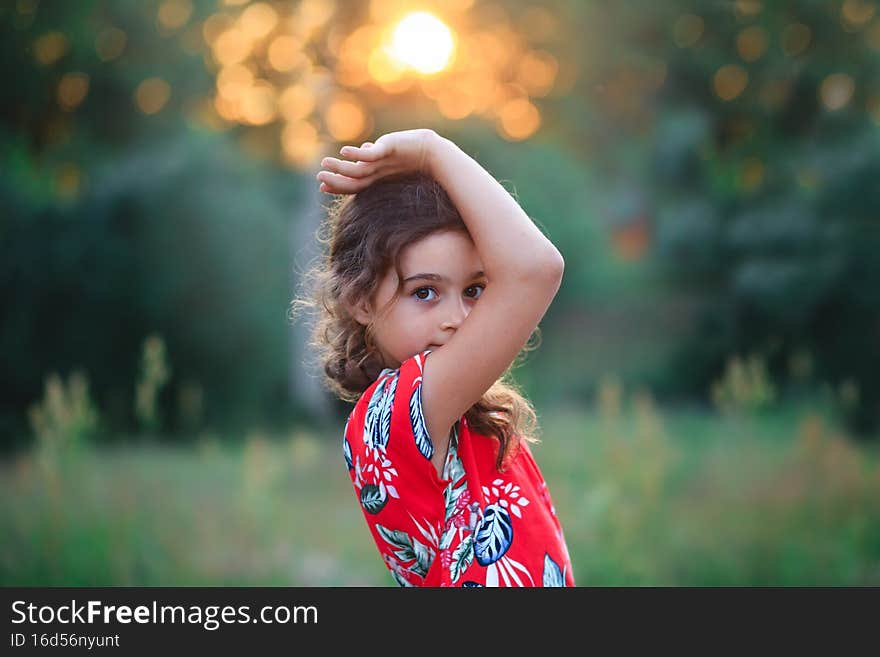 Portrait of  cute Child playing on outdoor playground. Healthy summer activity for children in sunny weather. Cute girl smiling. Soft focused