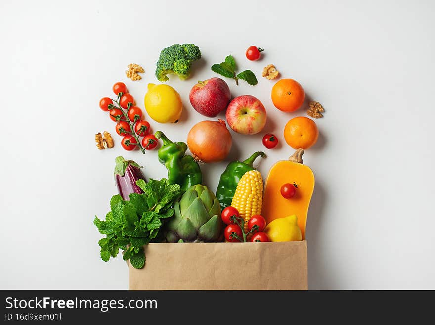 Delivery healthy food background. Healthy vegan vegetarian food in paper bag vegetables and fruits on white, copy space