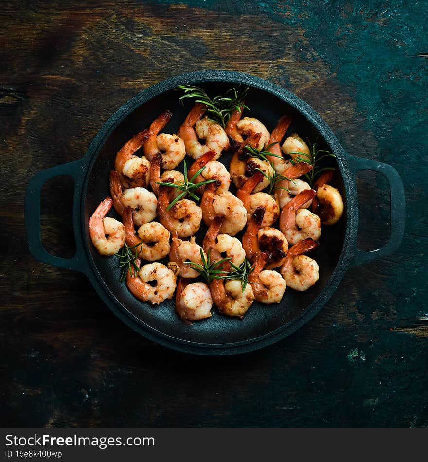 Fried shrimp with garlic and lemon in a pan. Seafood.