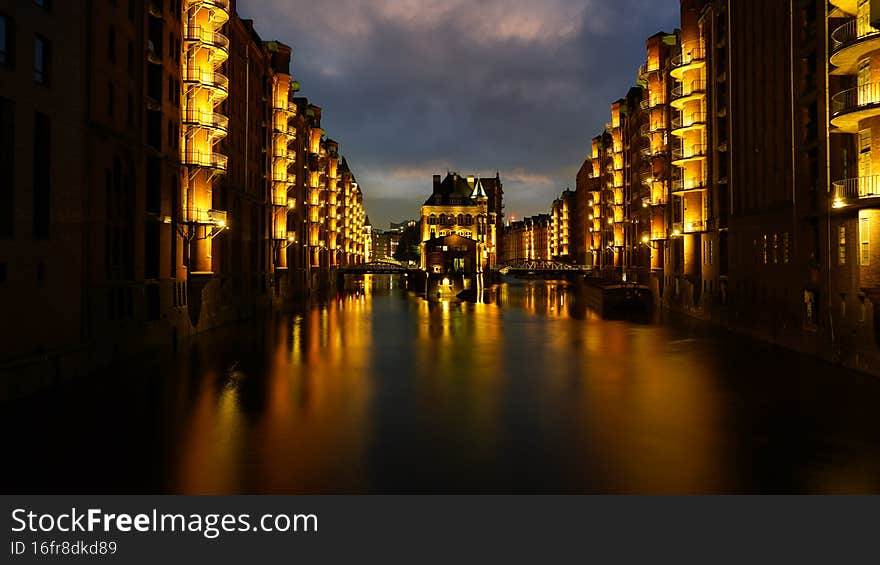Hamburg Speicherstadt in the night with the famous illuminated moated castle. Hamburg Speicherstadt in the night with the famous illuminated moated castle