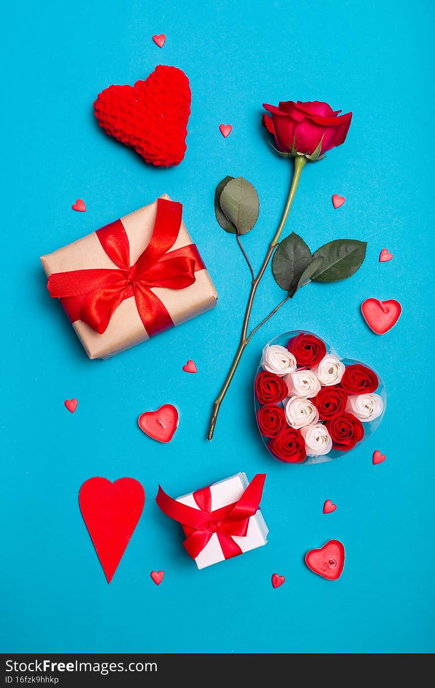 Valentine s Day background. Gifts, candle, confetti, envelope on pastel blue background. Valentines day concept.