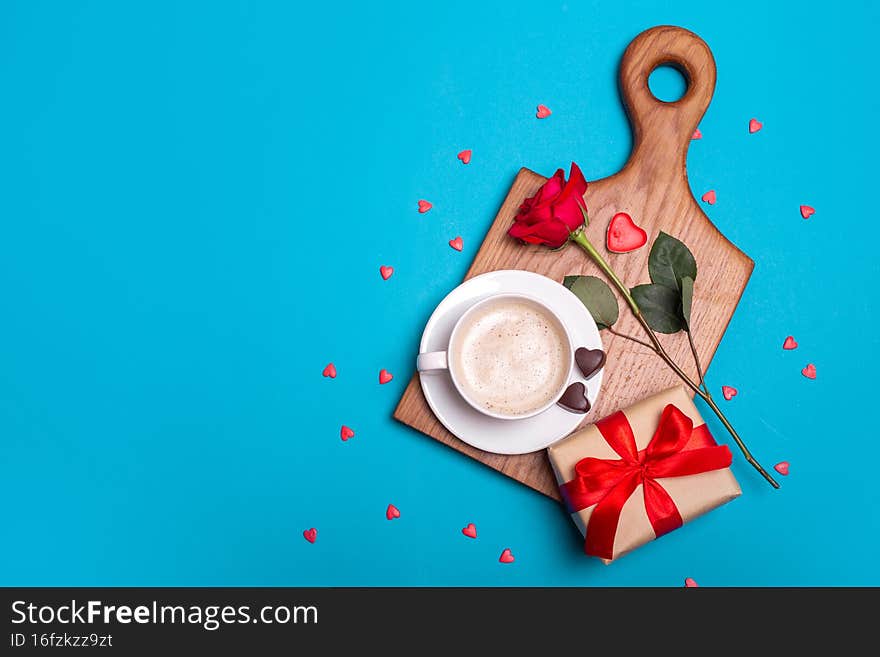 Valentine& x27;s Day breakfast in bed. Gift, coffee rose, candles, hearts on blue background. Valentines day concept.