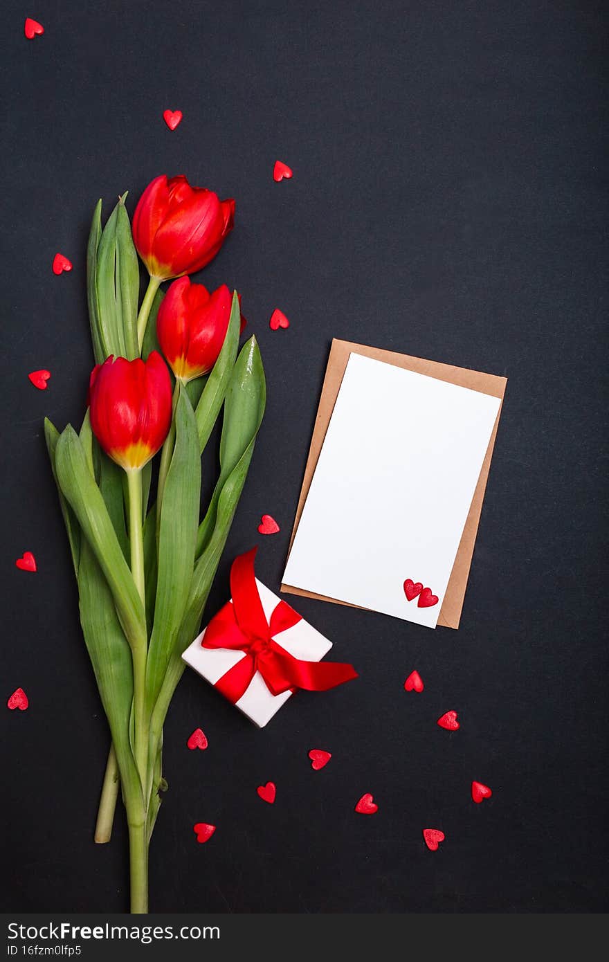 gift box, blank, flowers and a paper hearts on a black background for Valentine s Day. Mother s Day. Happy