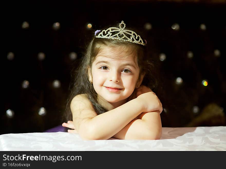 Beautiful little girl of preschool age in a cute white dress