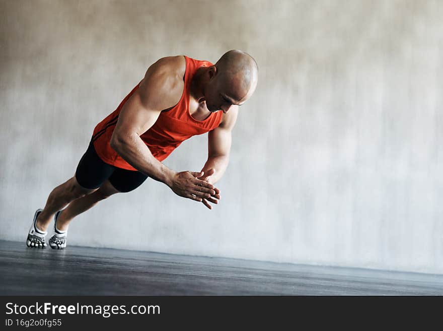 Faster, harder, stronger. Shot of a man doing exercises at the gym.