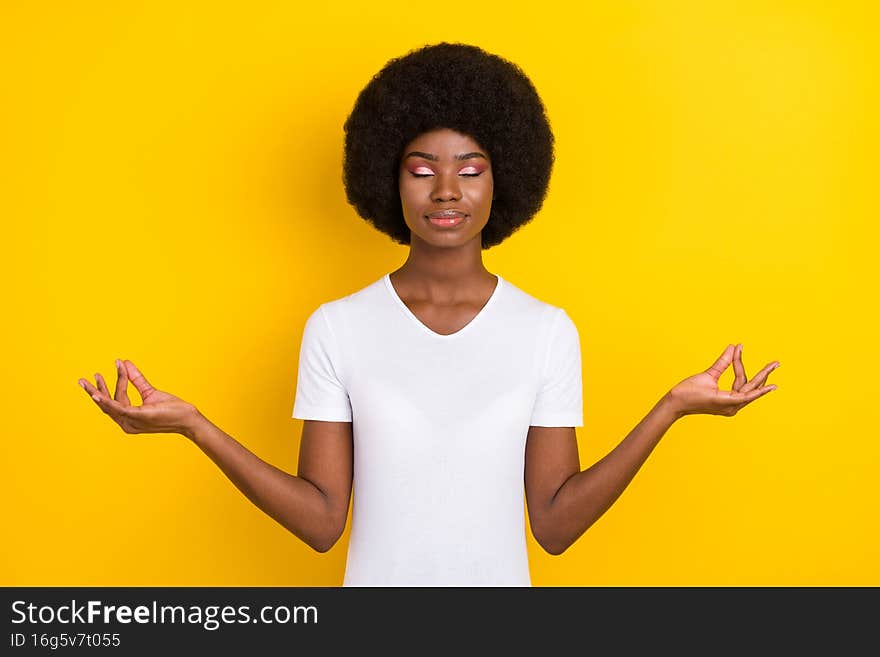 Photo of calm peaceful nice young afro american woman make om signs isolated on yellow color background