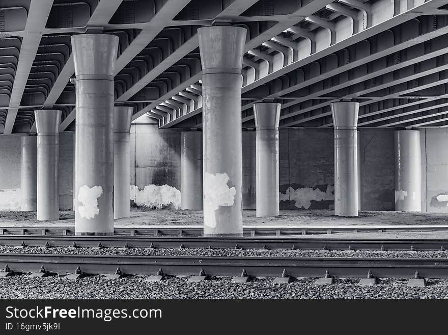 Railway tracks under the concrete bridge. Railway tracks under the concrete bridge