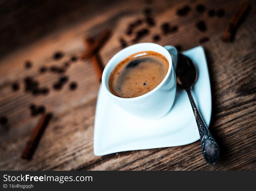 White porcelain cup of coffee  on wooden background. White porcelain cup of coffee  on wooden background