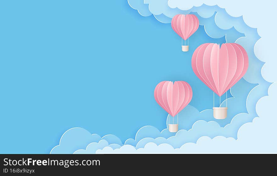 Pink balloons on the blue cloudy sky