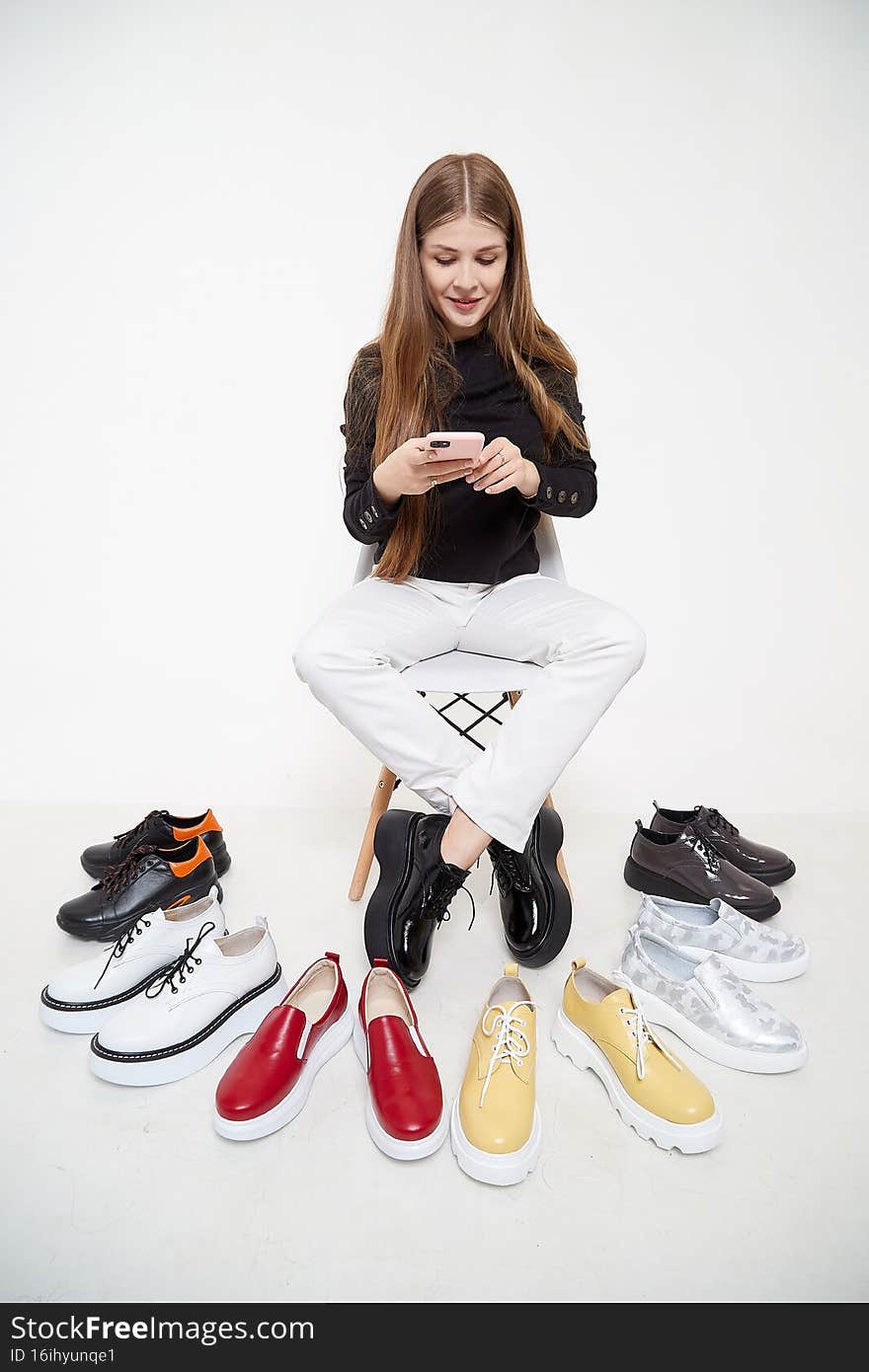 Beautiful young woman or girl wearing casual clothes on white background. Young female model posing during photo shoot