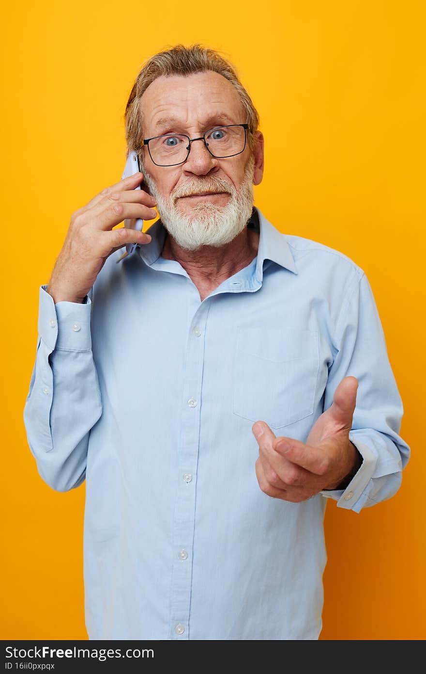 Portrait of happy senior man talking on the phone emotions isolated background. High quality photo
