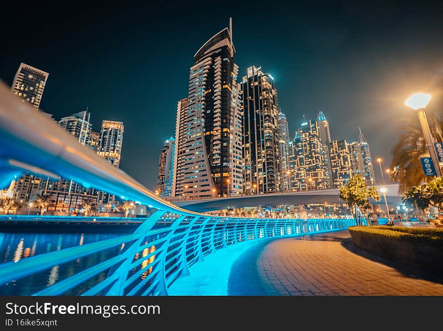 Dubai downtown night scene, UAE, beautiful modern buildings, bright glowing lights, luxurious travel and tourism. Dubai downtown night scene, UAE, beautiful modern buildings, bright glowing lights, luxurious travel and tourism