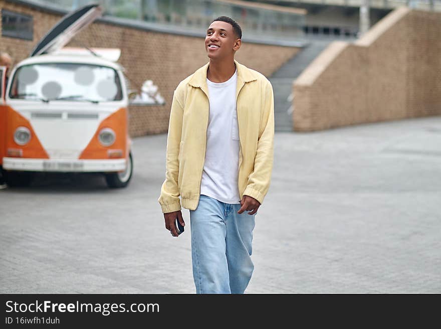 Man walking in city looking up and aside