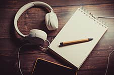 Headphones And Notepad For Recordings Stock Photo