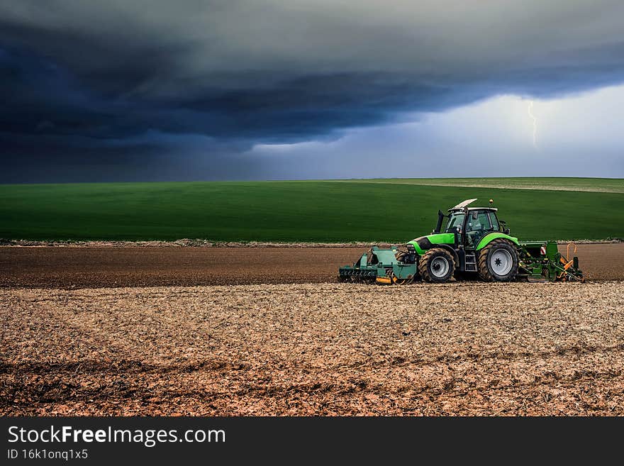 tractor equip with seeder working in the fields. tractor equip with seeder working in the fields