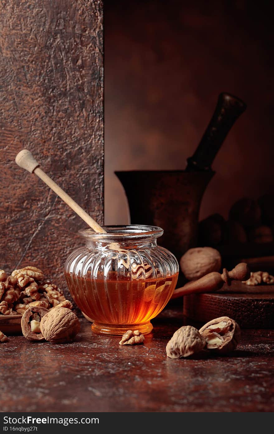 Honey and walnuts on an old kitchen table