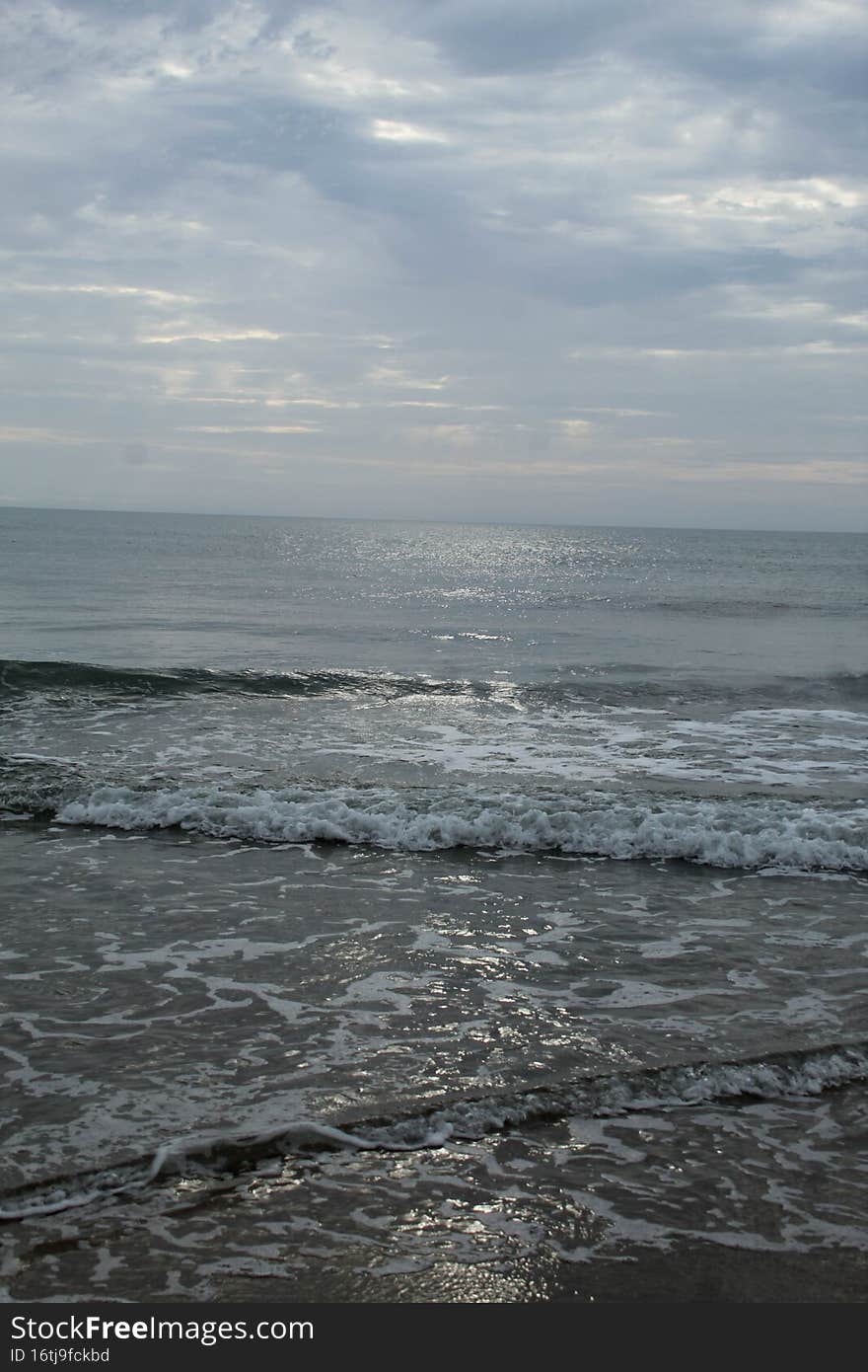 Calmness of the ocean waves, in a overcast sky   OUTERBANKS NORTH CAROLINA