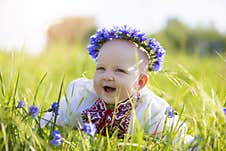 A Happy Little Girl In National Belarusian Or Ukrainian Clothes Lies On The Grass And Laughs Stock Photography