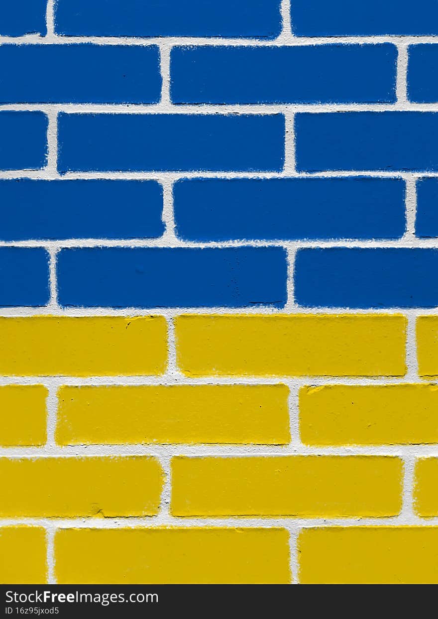 Wall painted with blue and yellow colors of Ukraine flag. Political background, power in the state. Wall painted with blue and yellow colors of Ukraine flag. Political background, power in the state