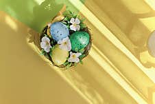 Easter Eggs With Flowers On A Yellow Background, Close Up Stock Photography