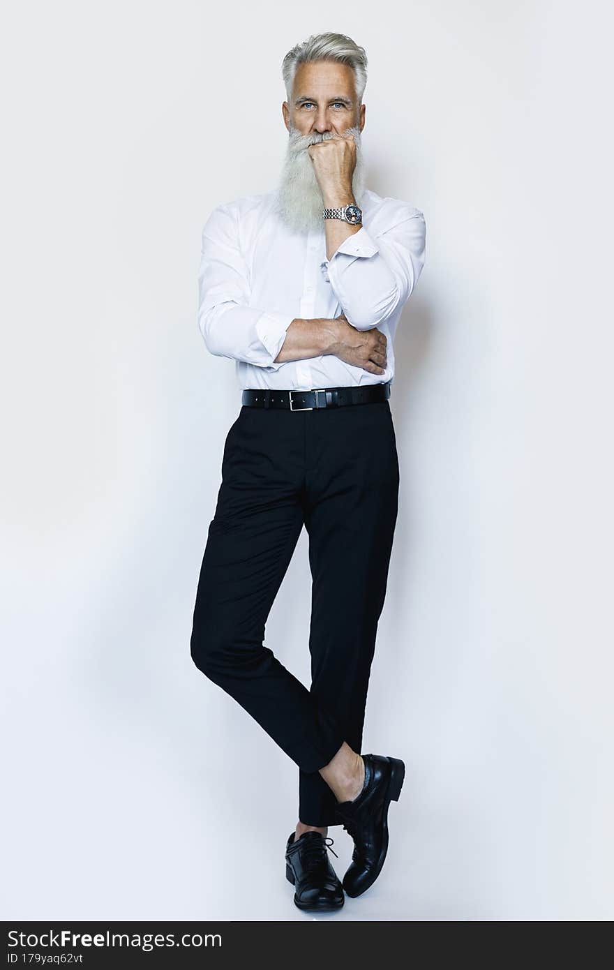 Stylish and handsome aged male model posing on white background