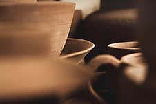 Shelves With Bowls, Plates, Jars, Teapots, Etc. Made In Clay In Natural Raw Color Until The Final Painting. Crafts In Clay Royalty Free Stock Photo