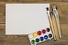 Paint Brushes On Old Wooden Background With Blank Vintage Paper Royalty Free Stock Photo