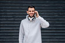 Man Walking With Mobile Phone And Headphones Royalty Free Stock Images