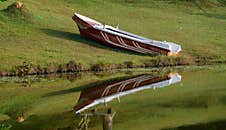 Motorboat On The Shore And Its Reflection On The Waters Of Hiyare Resovior Royalty Free Stock Image