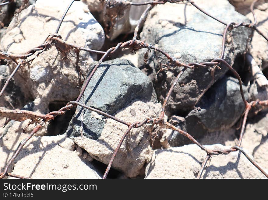 Iron Rusty Net On The Rocks