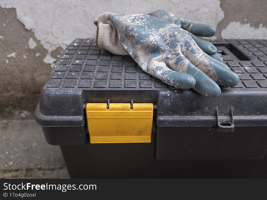 Discarded work gloves on a tool box