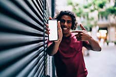 Male Blogger Showing Mobile Notification For App Installation Royalty Free Stock Photography