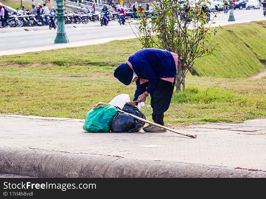 Old Man Collects Bottles In The City