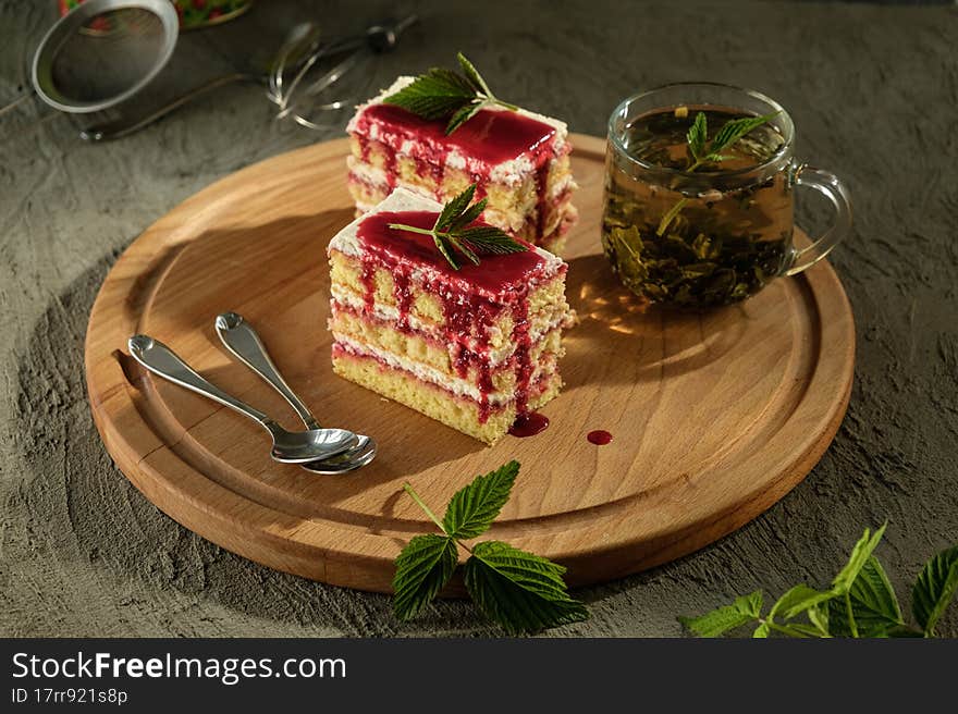 Delicious dessert biscuit with raspberries and green fragrant tea, home decor, gray background