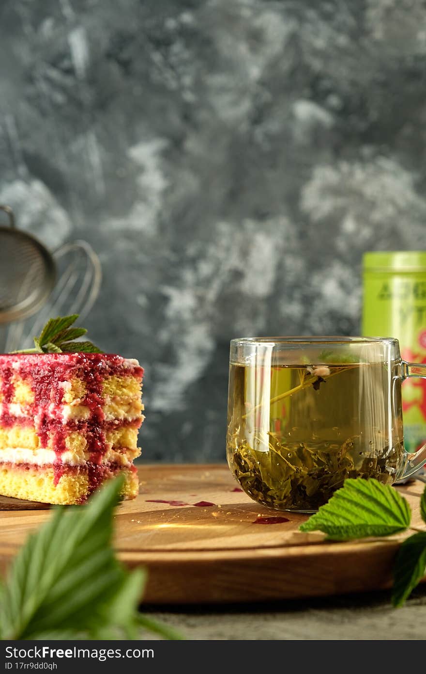 Delicious dessert biscuit with raspberries and green fragrant tea, home decor, gray background