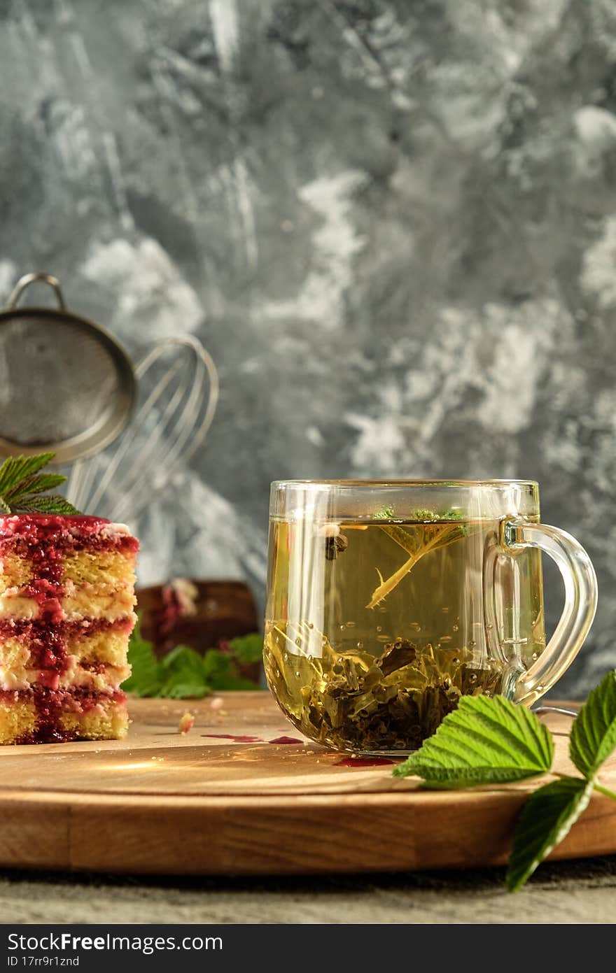 Delicious dessert biscuit with raspberries and green fragrant tea, home decor, gray background