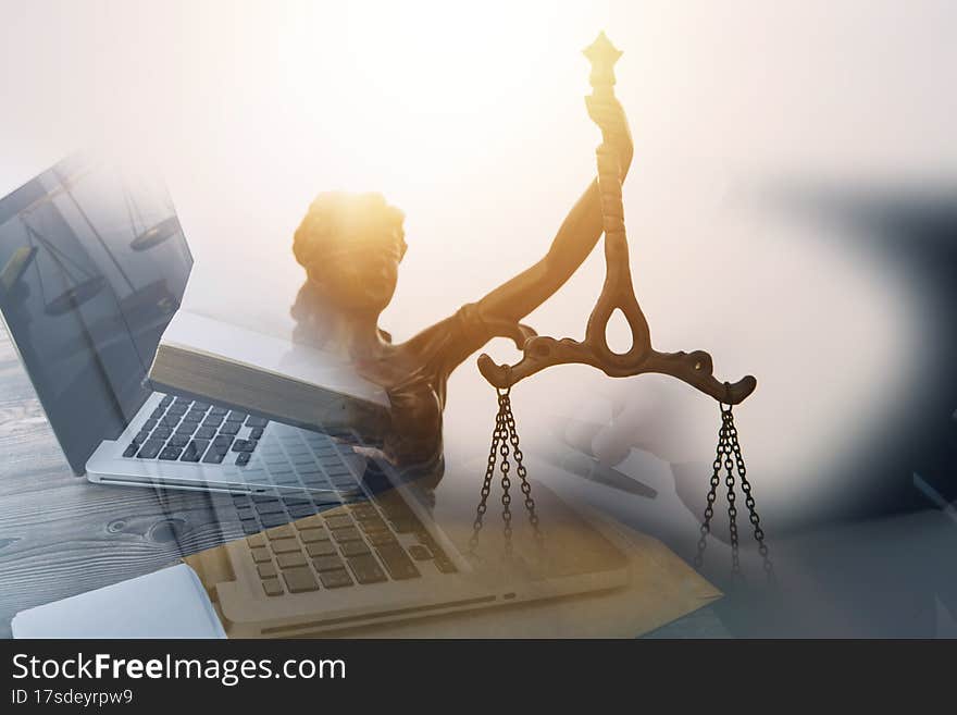 Justice and law concept.Male judge in a courtroom with the gavel, working with, computer and docking keyboard, eyeglasses, on