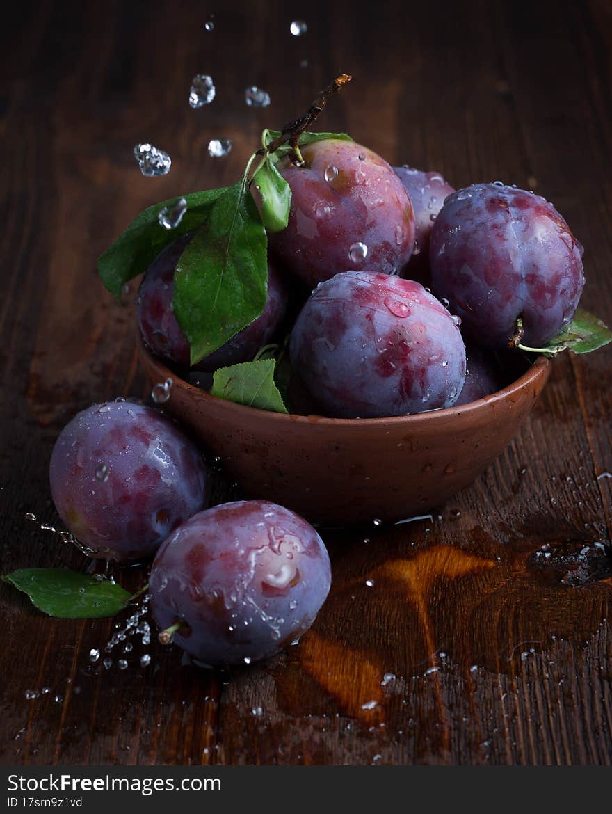 Fresh plums on a dark background