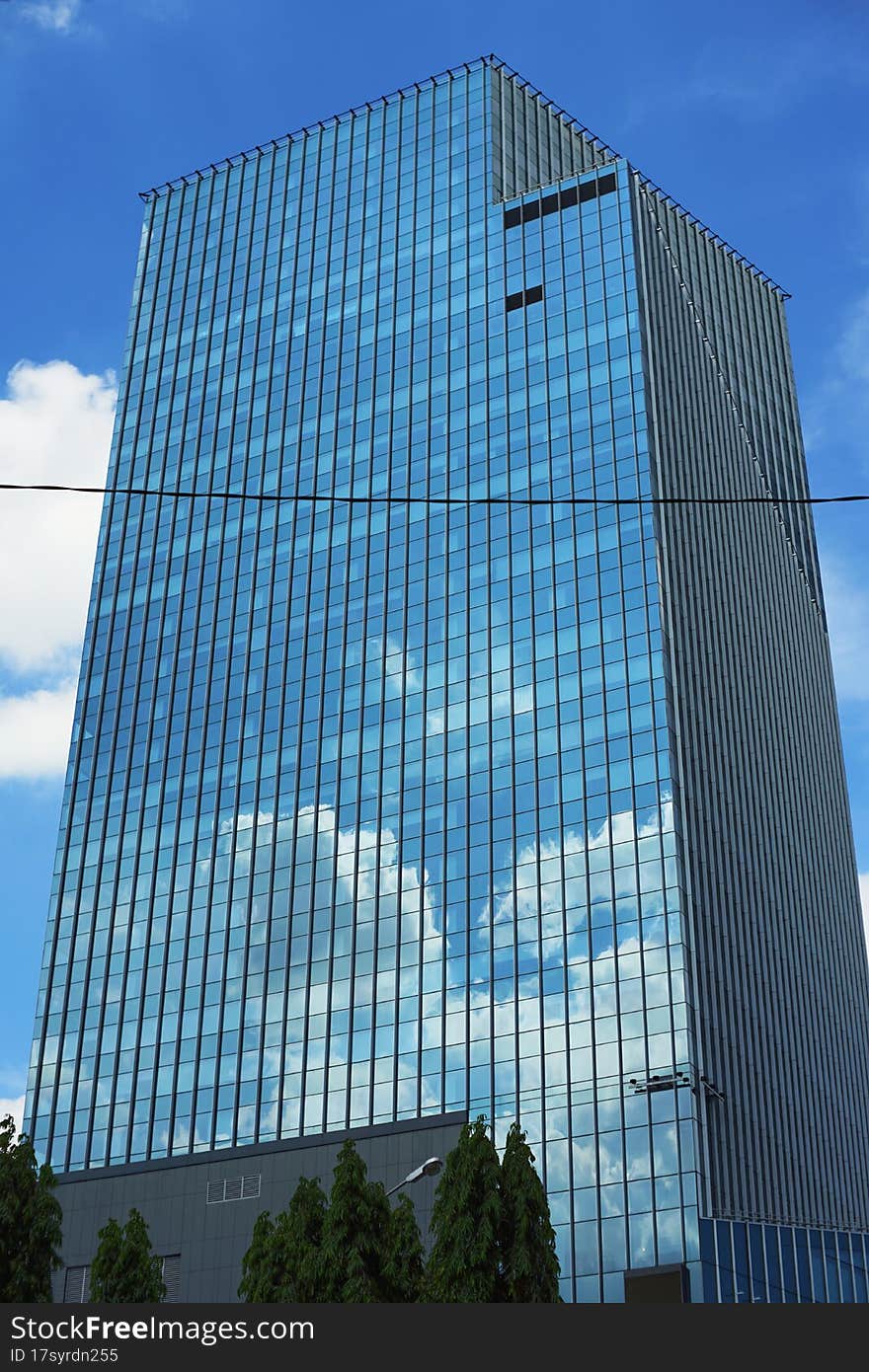 Tower in bangkok on blue sky with cloud reflect