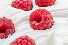 Fresh Raspberries In The Yoghurt Or Cream. Top View Royalty Free Stock Photos